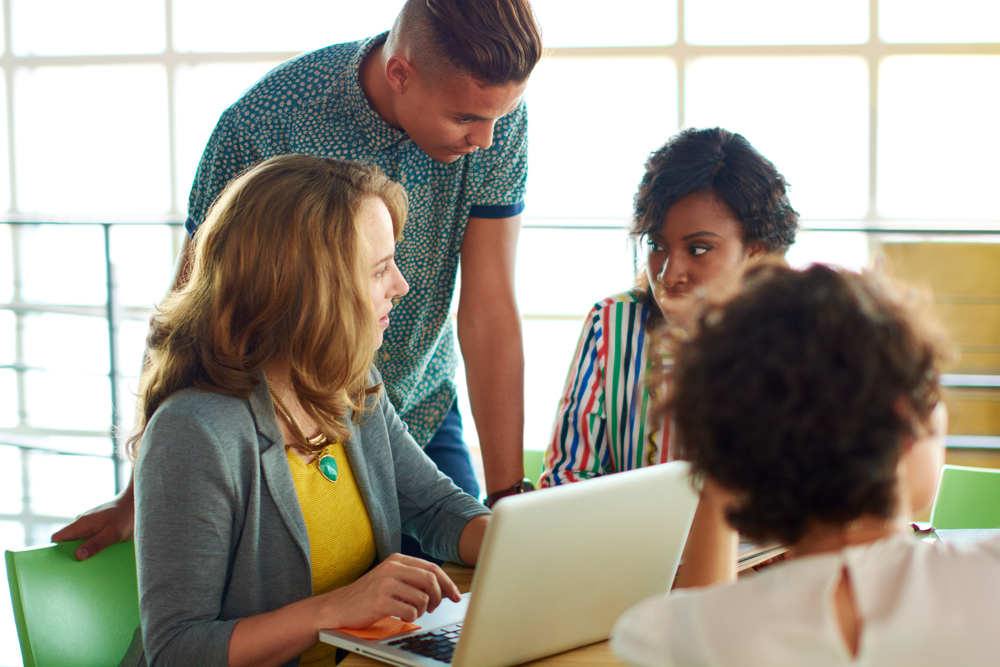 Candid image of a group with succesful business people caught in an animated brainstorming meeting